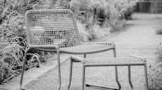 an orange garden chair with a footstool