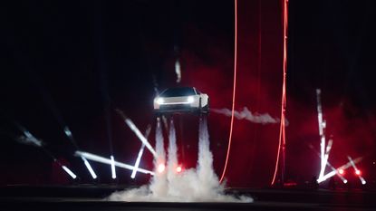 A car spews steam underneath it as it hovers in the air