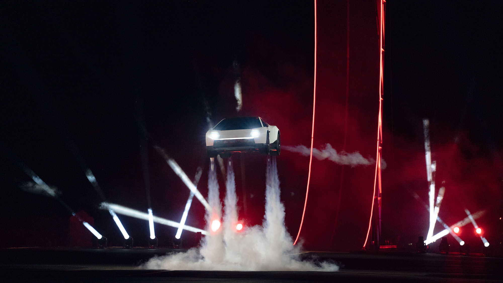 A car spews steam underneath it as it hovers in the air