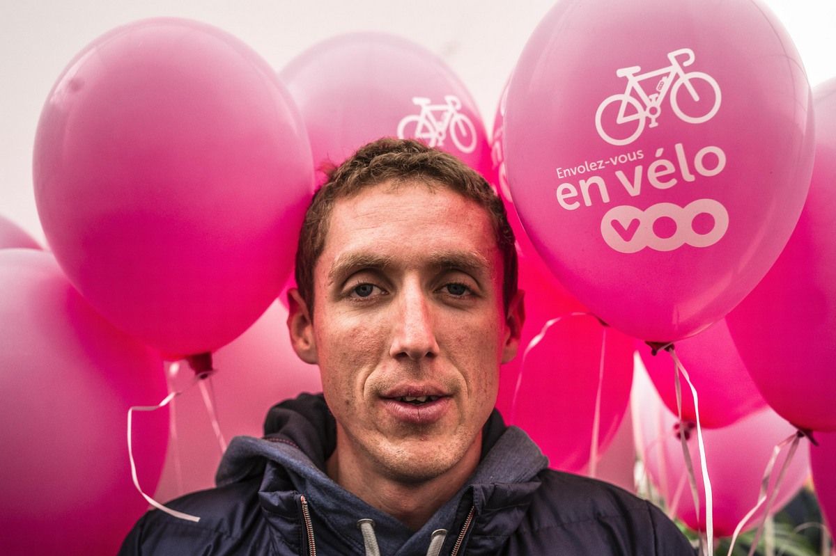 Dan Martin is surrounded by pink balloons