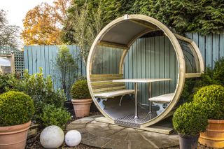 Unique Garden Wheel Bench in a small garden patio as garden dining seating