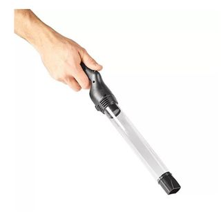 Hand holding the clear plastic and black handled insect vacuum