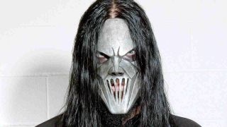 Slipknot’s Mick Thomson posing for a photograph in a steel-plate mask 