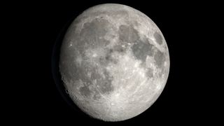 A close up of the moon in space, with various features like lunar seas and craters labeled and designated