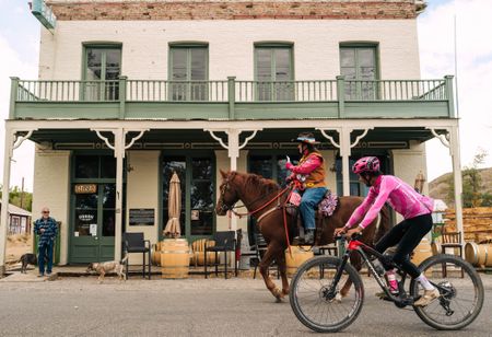 Lachlan Morton rides through a small town on his seventh and final day across the Pony Express trail