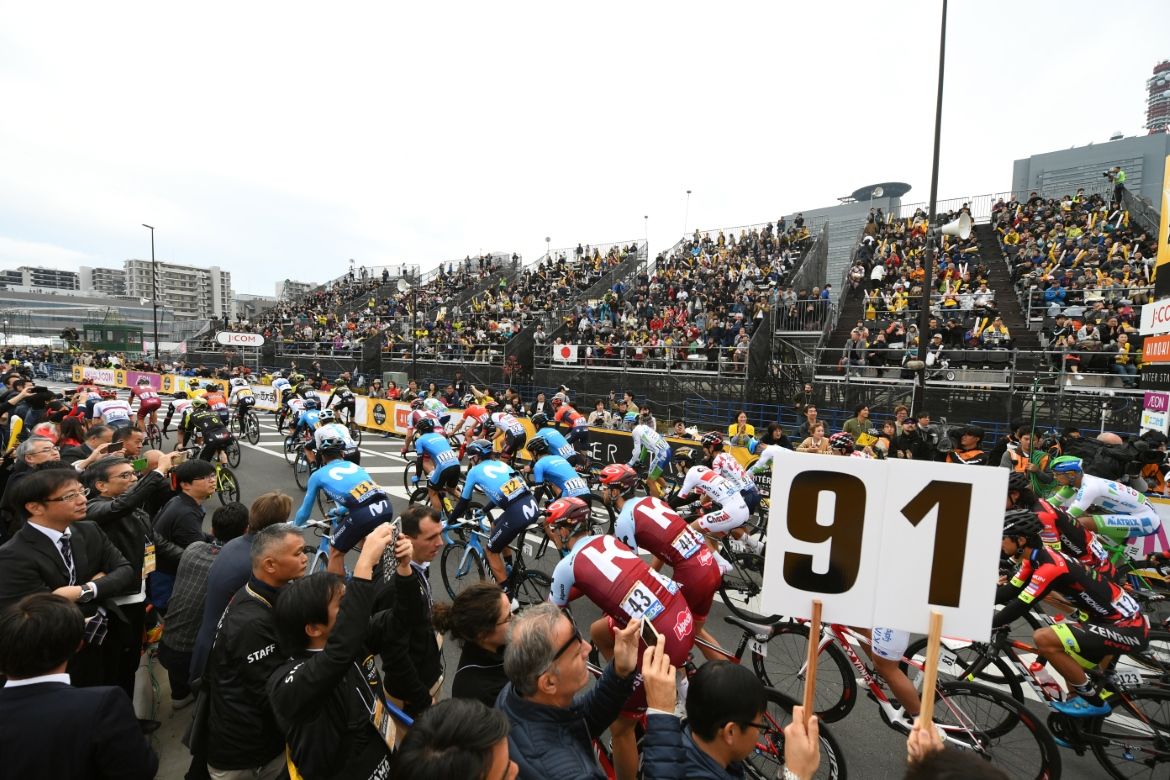 The riders pass through the fans