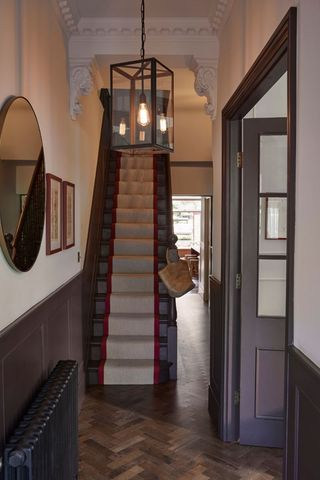 hallway with mirror and statement light