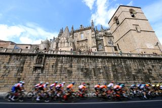 ALTO DEL PIORNAL SPAIN SEPTEMBER 08 A general view of the peloton passing through the cathedral of Plasencia city during the 77th Tour of Spain 2022 Stage 18 a 192km stage from Trujillo to Alto del Piornal 1163m LaVuelta22 WorldTour on September 08 2022 in Alto del Piornal Caceres Spain Photo by Tim de WaeleGetty Images