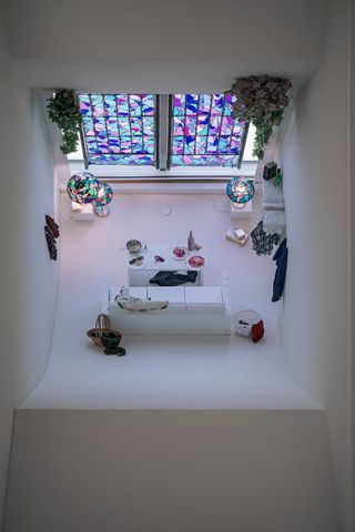All white room with stained glass panel wall