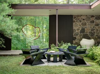 On the other side is a set of pine outdoor furniture by Green River Project LLC and a stone vessel by Kazunori Hamana