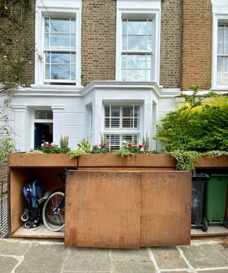 corten steel bike and bin storage in an urban front garden