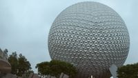 A screenshot of day breaking over the Epcot ball at Walt Disney World. 