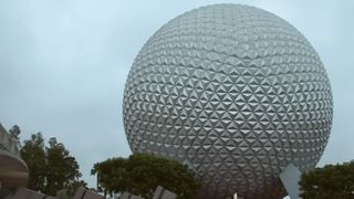 A screenshot of day breaking over the Epcot ball at Walt Disney World. 