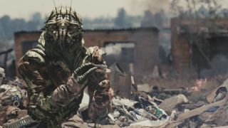 A prawn holding trash during one of the best sci-fi movies of all time, District 9.