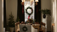 A Christmas table decorated with seasonal greenery