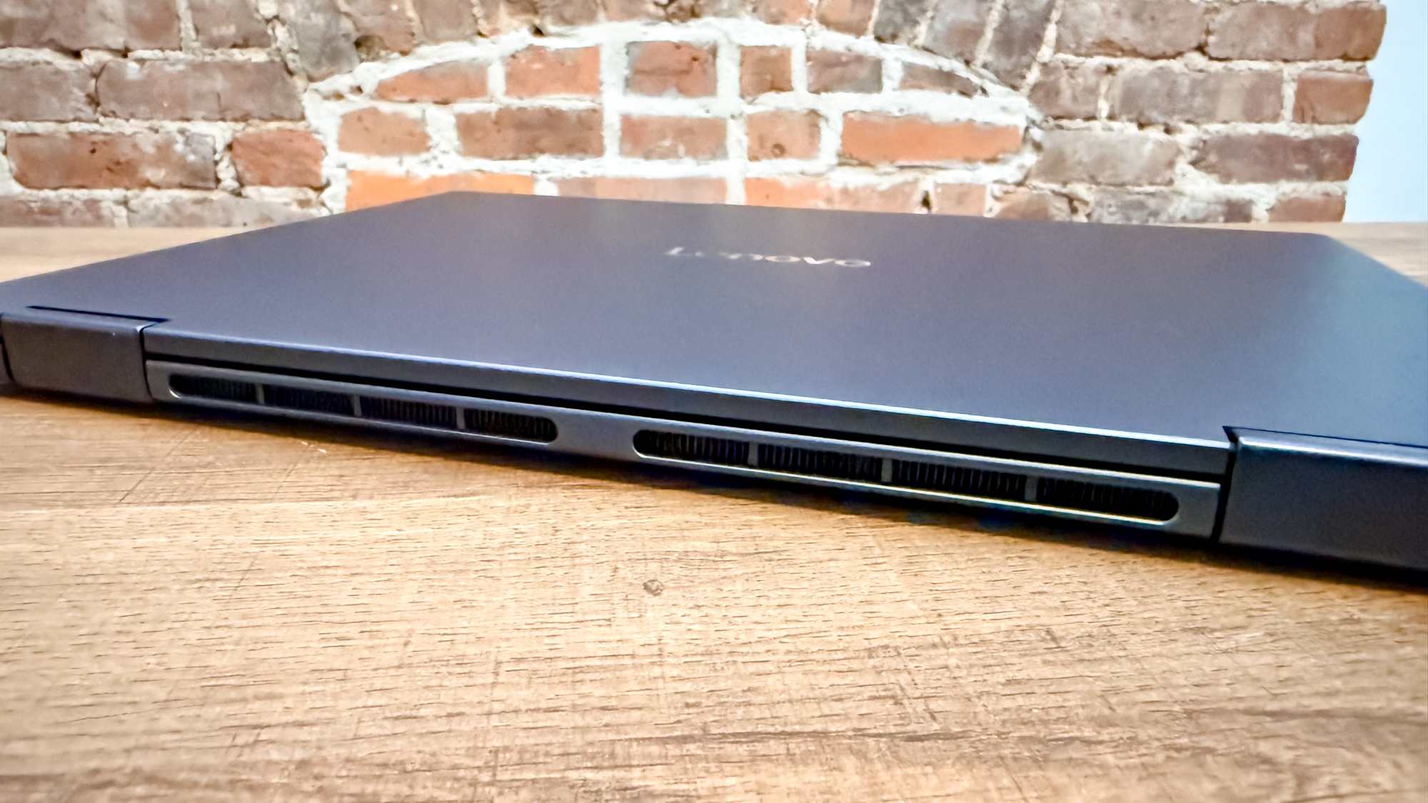 The Lenovo Chromebook Plus 2-in-1 Gen 10 with its lid closed showing off its hinge on a table
