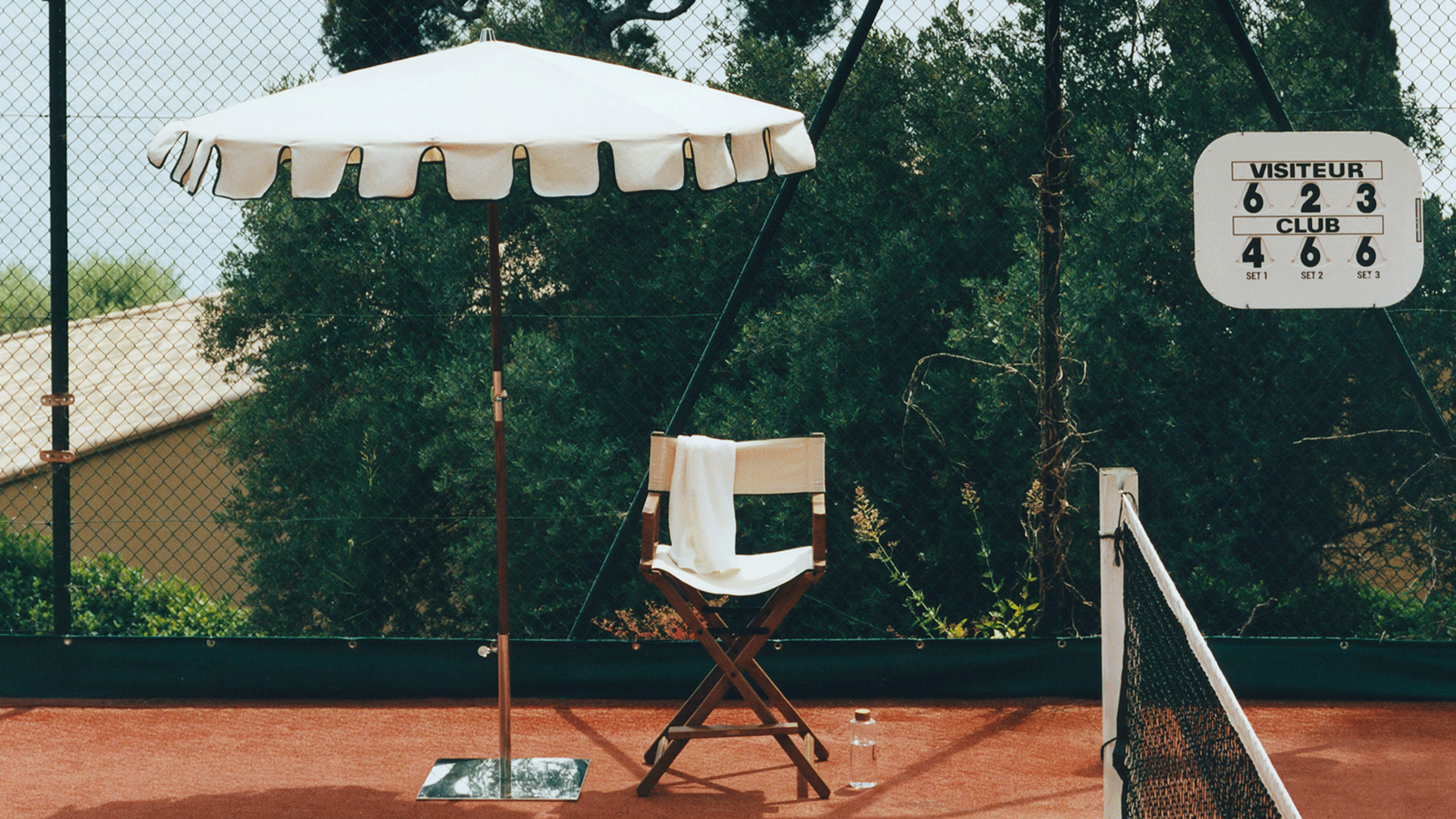 Zara Home collection styled on tennis court with outdoor umbrella