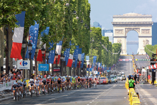 Women race in front of the Arch de Triomphe as the Tour de France name is returned