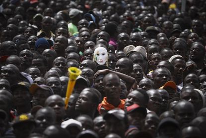 Supporters of the Kenyan opposition watch its leader Raila Odinga's 'swearing-in' ceremony in Nairobi.