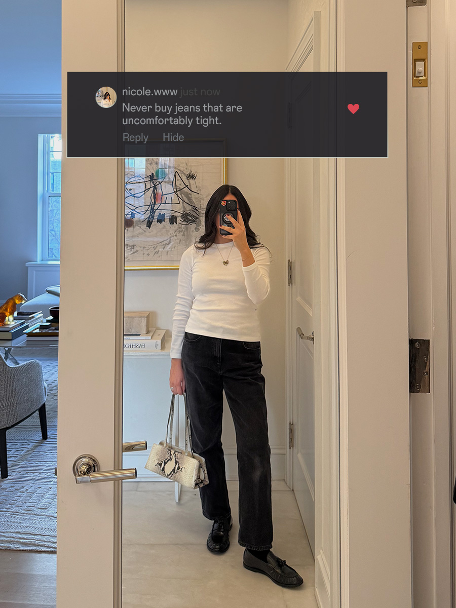 who what wear editor wearing black denim posing in front of a mirror