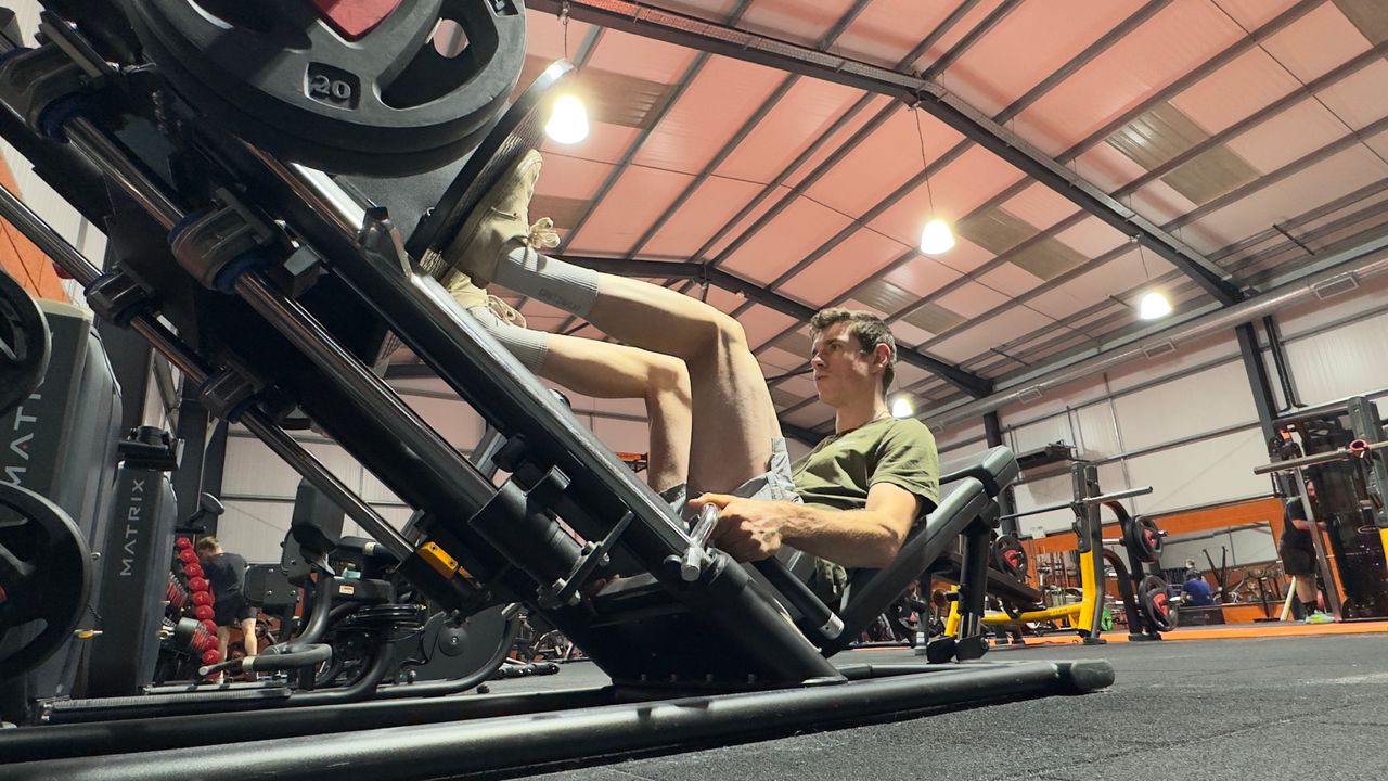 Tom Couzens using a leg press in the gym