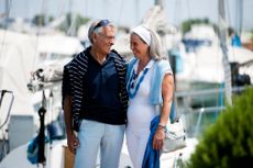DXFM4R Mature couple enjoying a stroll at a marina