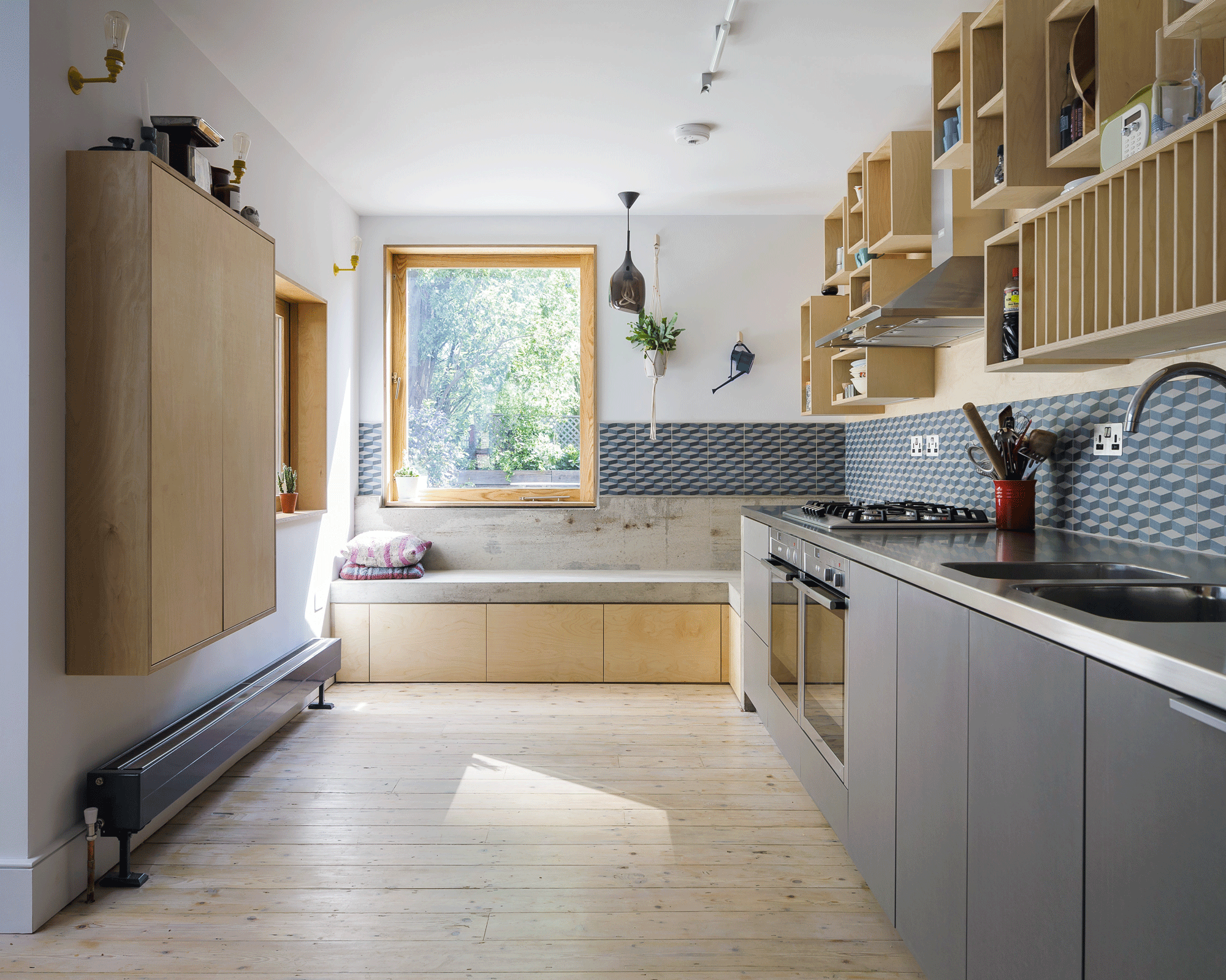 Kitchen with window seating made from a mix of concrete and plywood