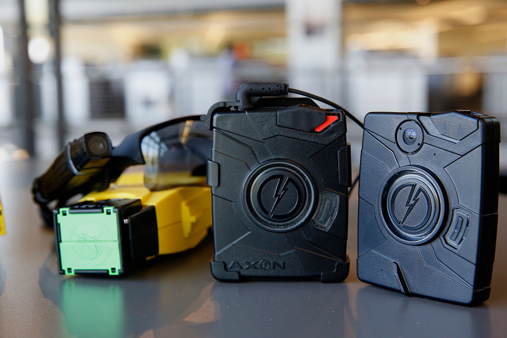 The Taser X26 smart weapon and AXON police body cameras are arranged for a photograph at the Taser International Inc. manufacturing facility in Scottsdale, Arizona.