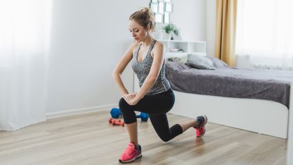 Woman completes a home workout in her living room