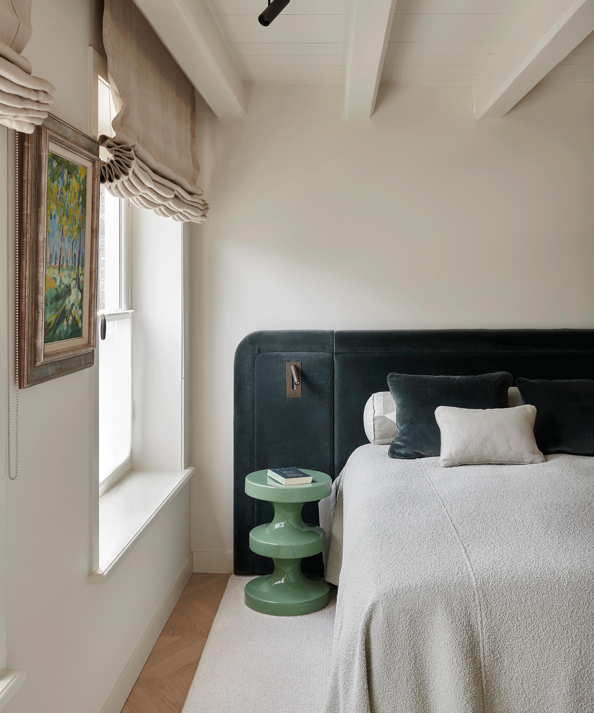 Beige bedroom with blue upholstered headboard