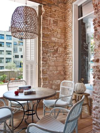 Rustic dining room in Barcalona apartment with rattan pendant light
