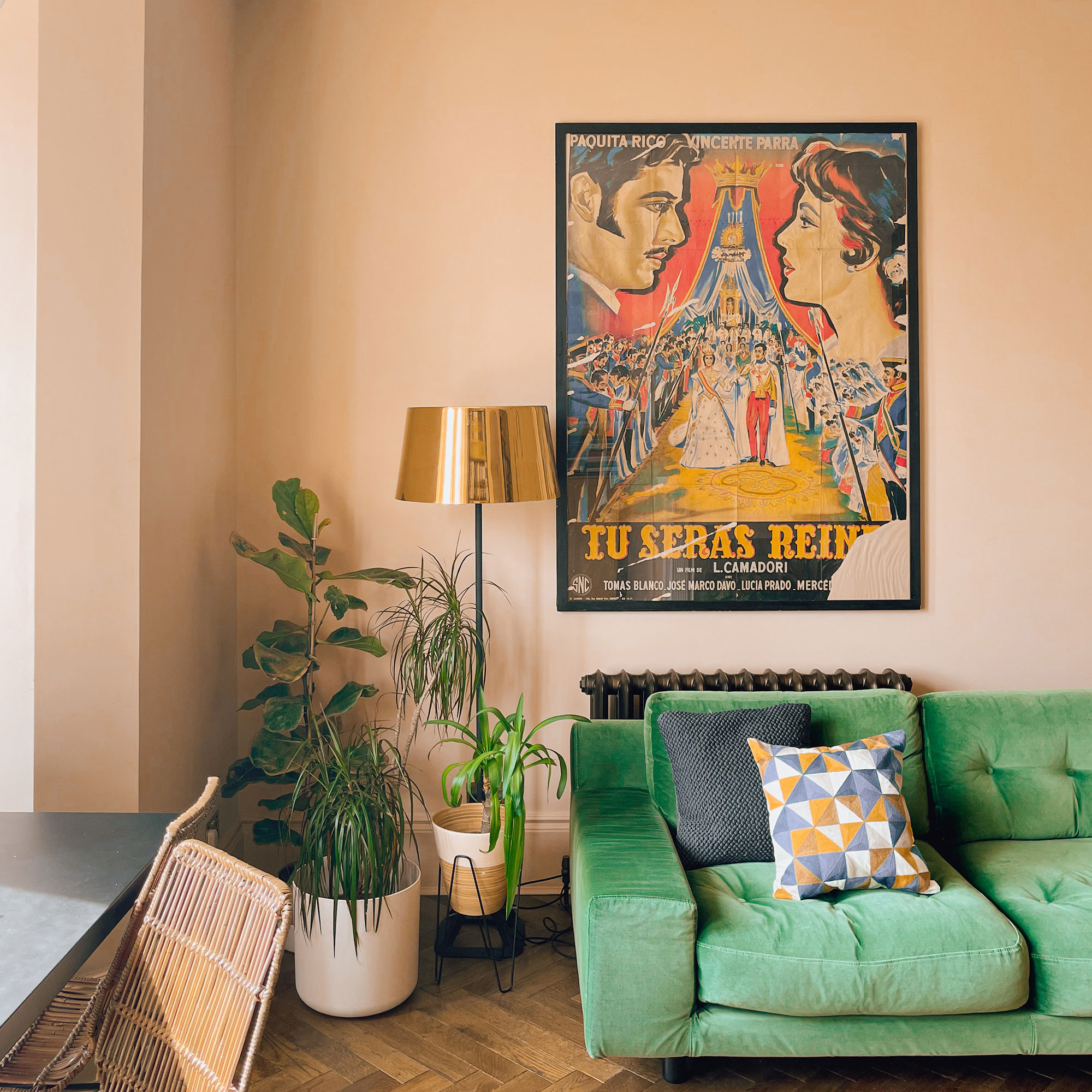 Green sofa beneath vintage film poster