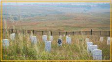 A view of a gravesite with various gray tombstones