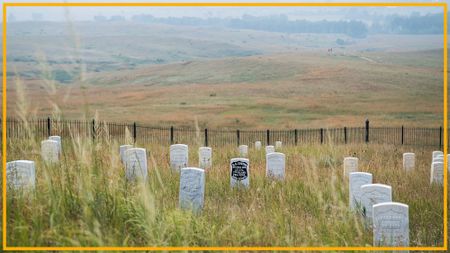 A view of a gravesite with various gray tombstones