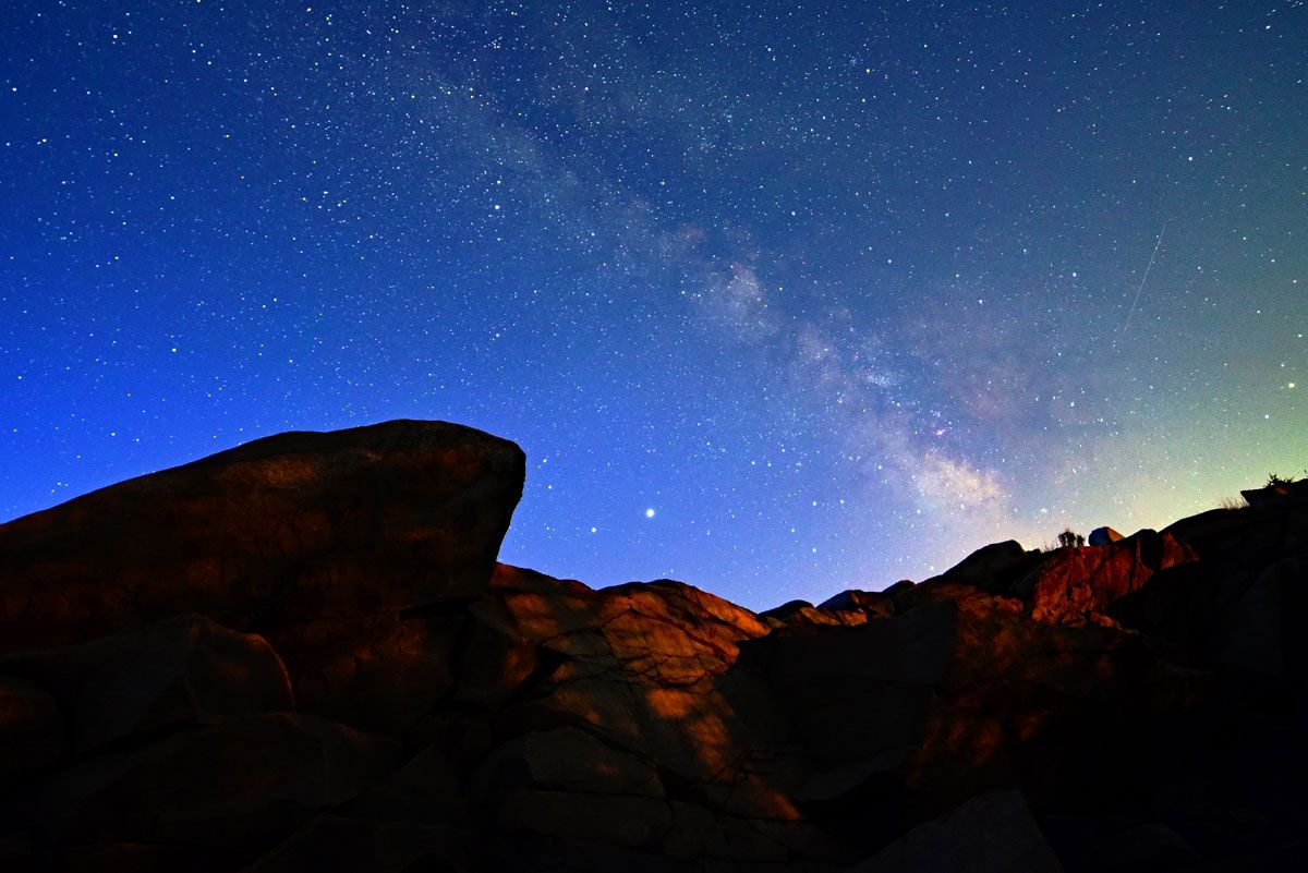 A faint Lyrid meteor is barely visible to the right of the Milky Way galaxy shortly before dawn on April 22, 2020, in this photo captured by Andrew March in Rockport, Massachusetts.