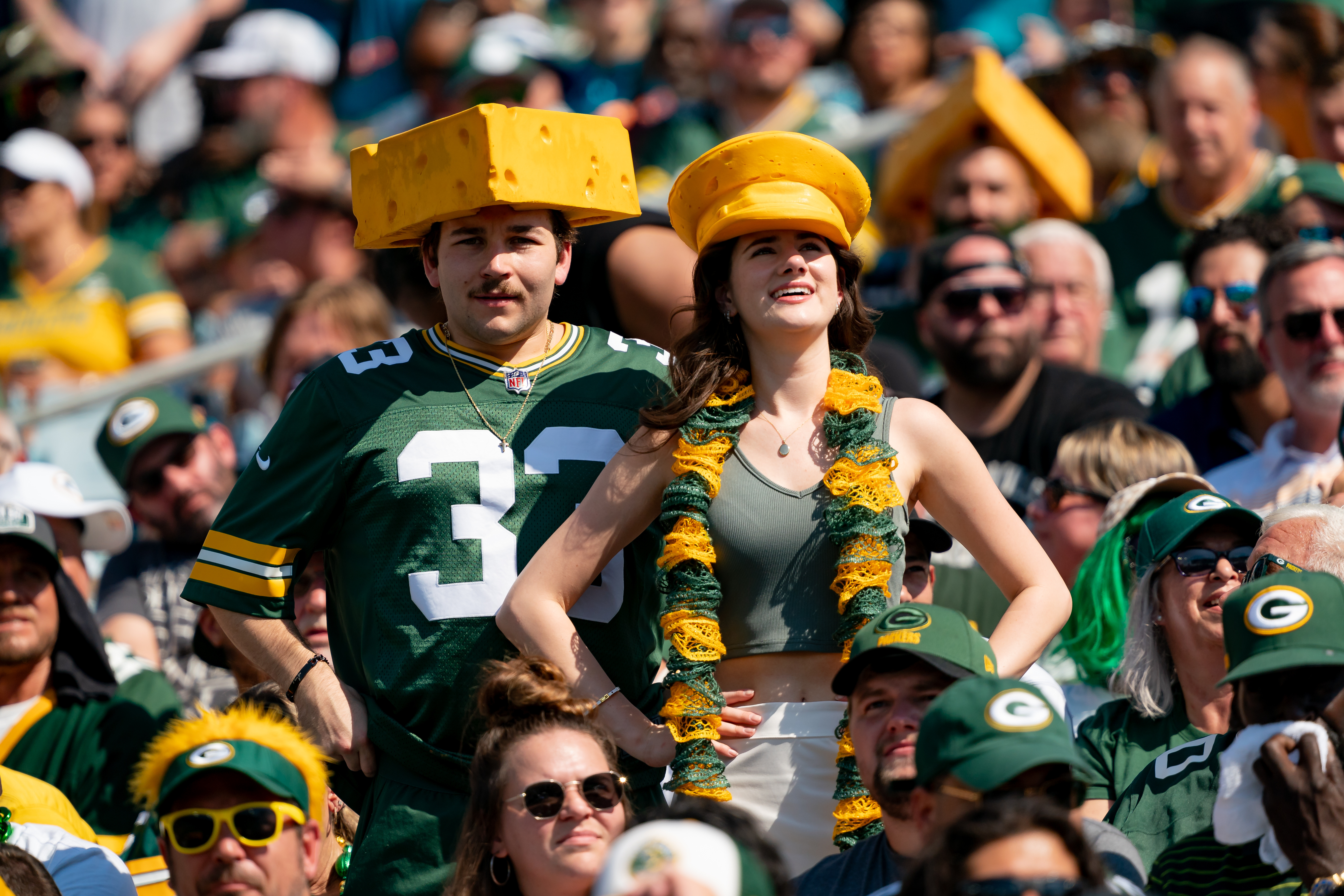 Two Green Bay Packers fans wear cheese head hats during a game against the Jaguars