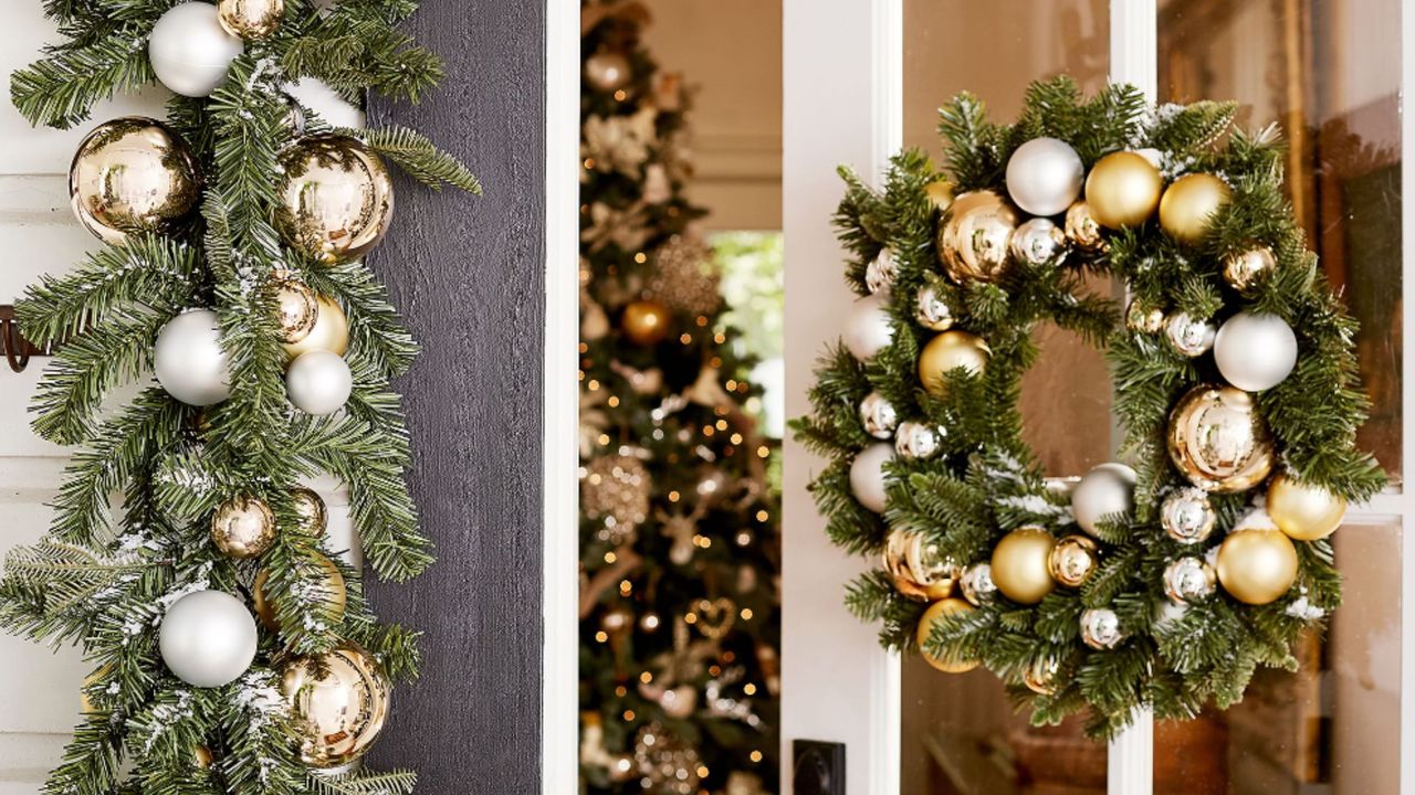 Pottery Barn christmas wreaths on door with christmas tree inside 