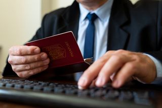 Passport details being checked through a computer 