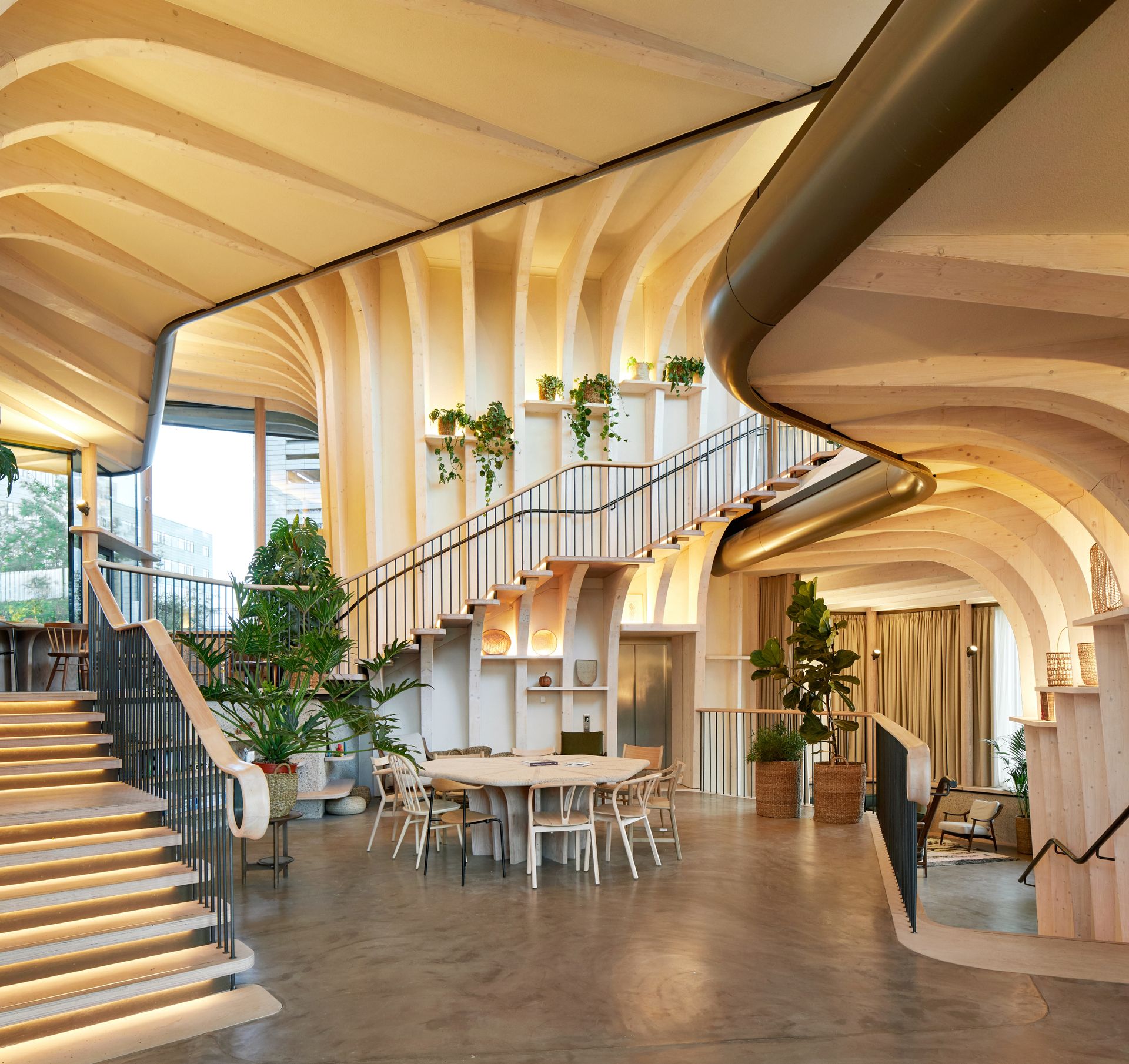 Open plan area with table and chairs and a staircase leading to second floor
