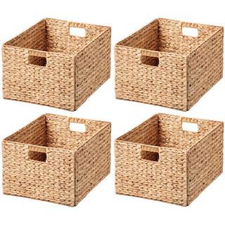 Four light brown woven storage bakets with cut out handles