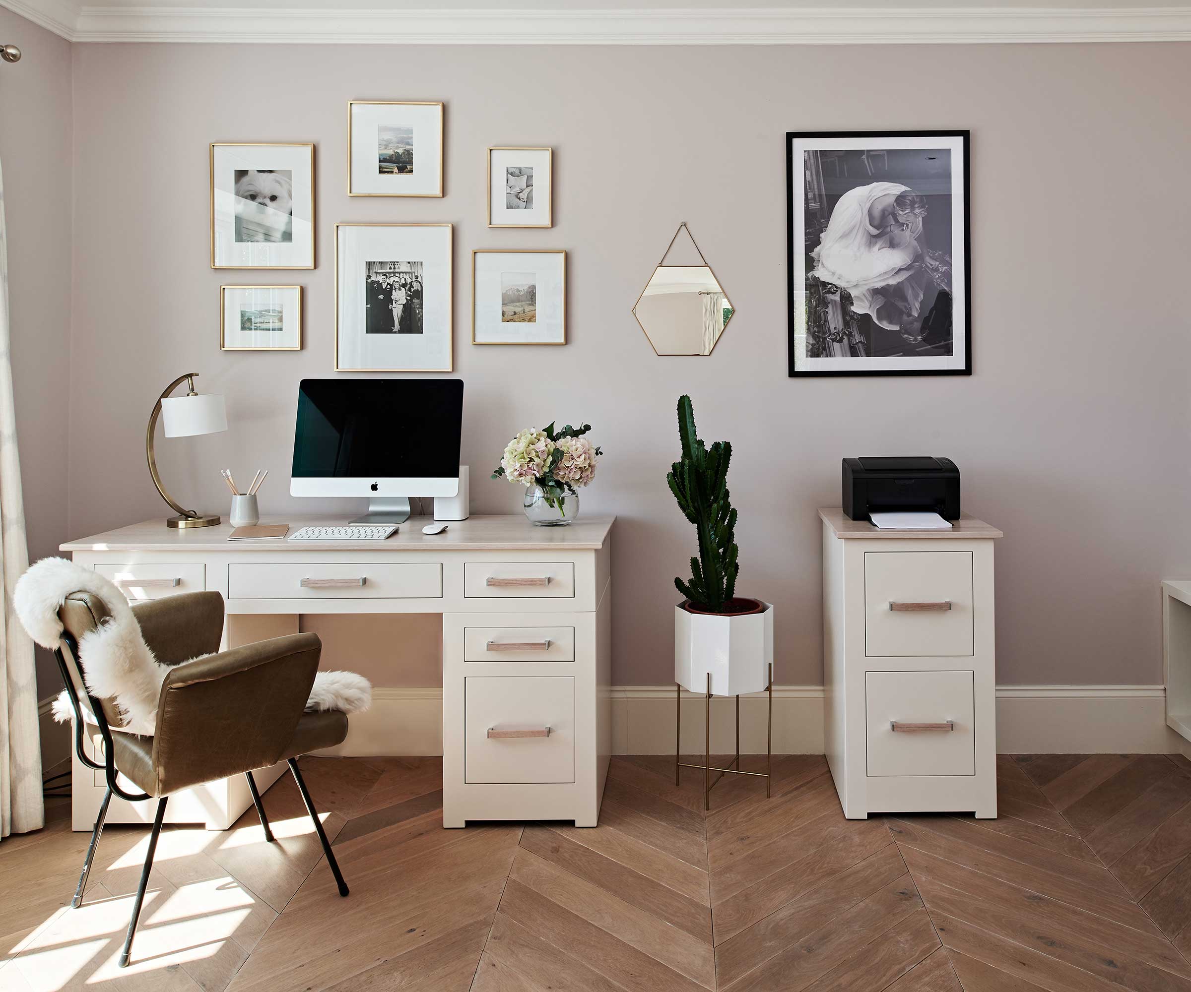 stylish home office with wooden herringbone flooring and cream painted office furniture