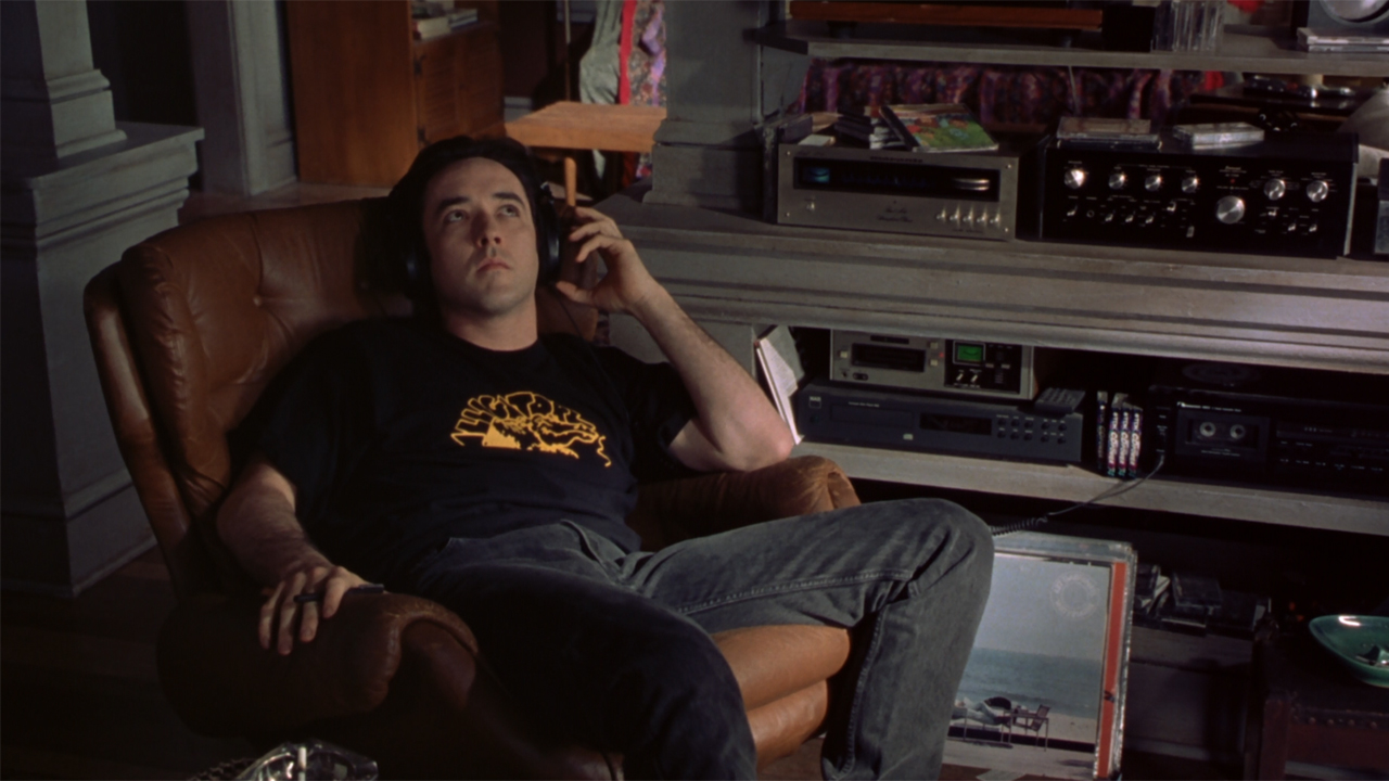 John Cusack as Rob Gordon with headphones in High Fidelity