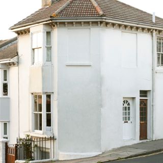 Exterior of house with white walls and white window frames