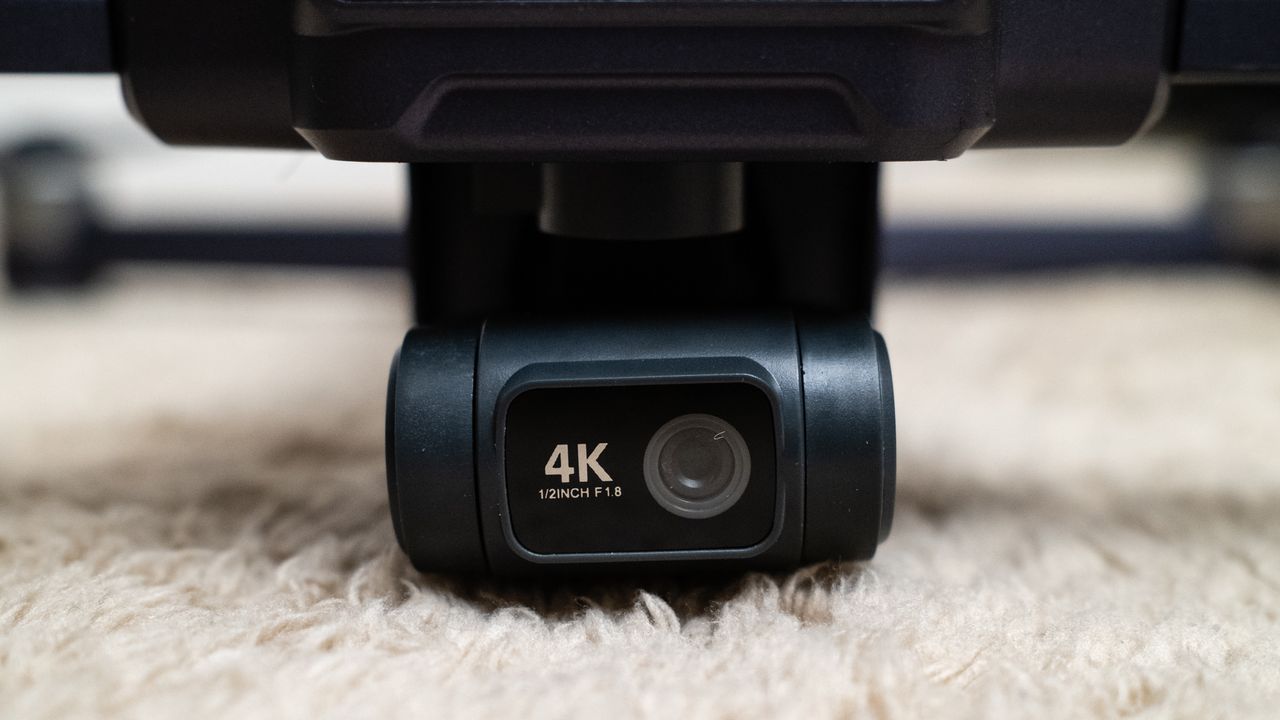 Close up of the 4K camera on a Veeniix V11PRO drone on a beige carpet
