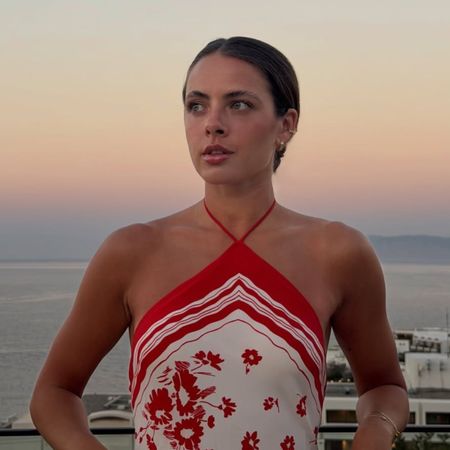 Tia Dewitt wear a falter neck top outfit. 