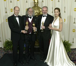 Winners for Best Art Direction (from L-R) Grant Major Actor Tim Robbins, Dan Hennah and Alan Lee pose with their Oscar alongside actress and presenter Angelina Jolie