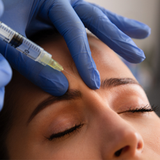 woman getting botox injected into her forehead