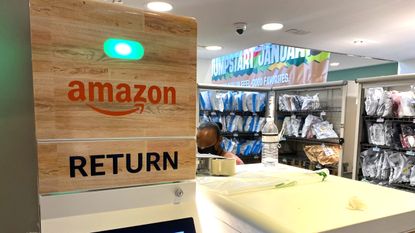 An Amazon return kiosk positioned next to rows of shelves with Amazon packages.