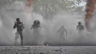 Wardogs four players running through smoke cloud