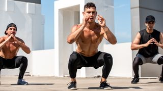 Three men performing body weight squats outside during a calisthenics workout